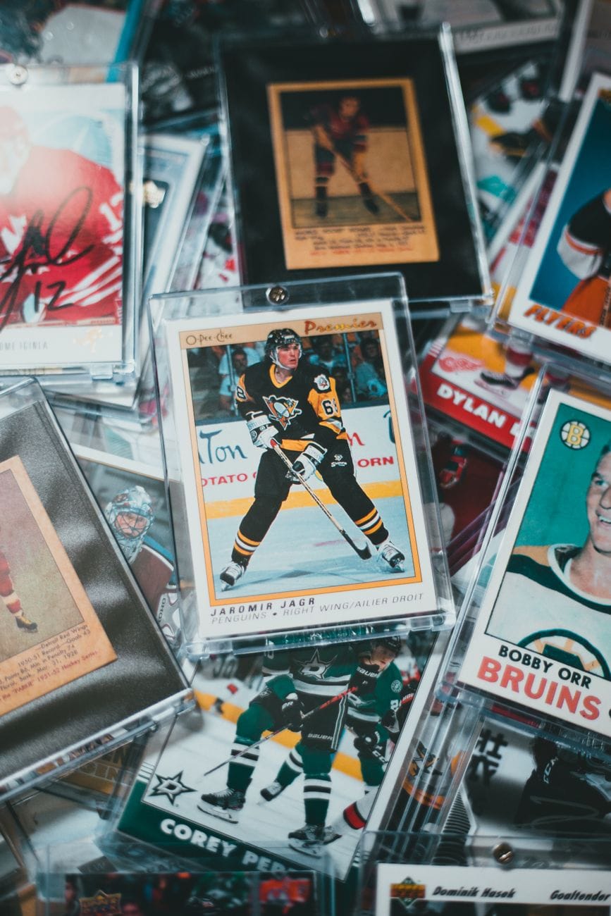 Sports card boxes and packs on a collector’s table with a release calendar open for upcoming trading card products