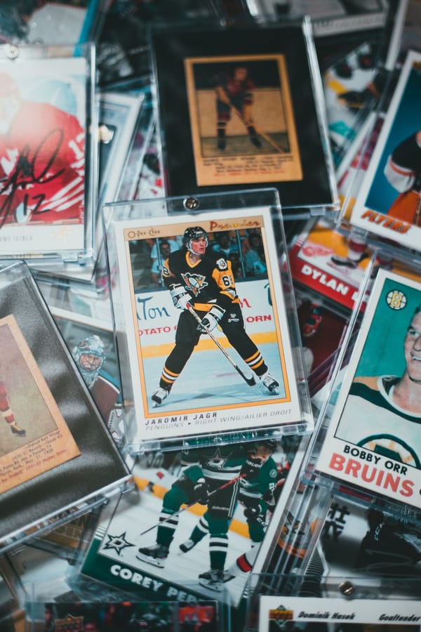 Sports card boxes and packs on a collector’s table with a release calendar open for upcoming trading card products