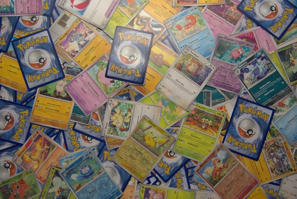 Rayquaza Pokémon trading card displayed on a collector table at a trading card shop.